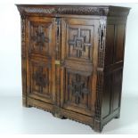 A late 18th / early 19th Century carved oak Cupboard, the cornice with lion mask heads,