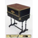 A rare and unusual red boulle brass inlaid and ebonised lift top Cabinet, by P.