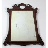 A Georgian period mahogany Wall Mirror, with shaped top and inset small circular mirror plate,