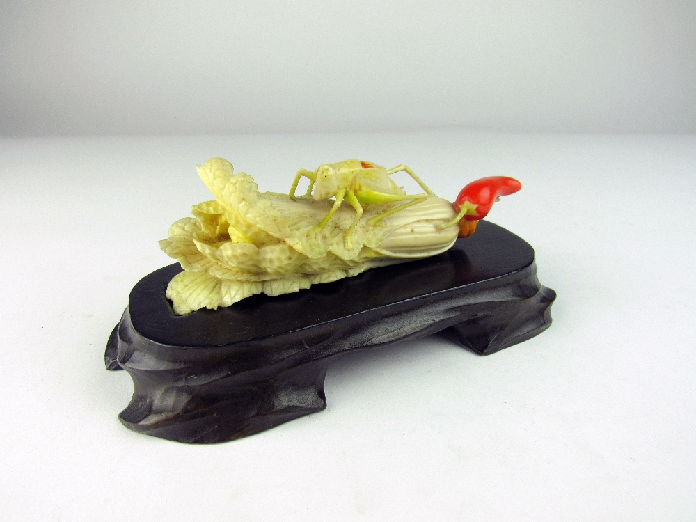 A very fine carved Meiji period Japanese ivory Okimono of a locust perched on a head of celery,