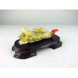 A very fine carved Meiji period Japanese ivory Okimono of a locust perched on a head of celery,