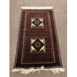 A large rust ground Oriental Rug, with large border, and two large square medallions in centre,