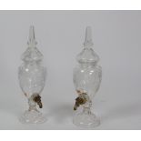 A pair of large glass Brandy Dispensers, on moulded bases.