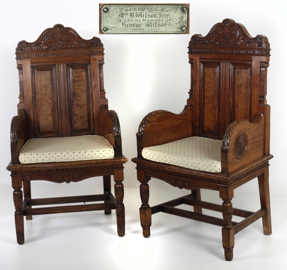 A pair of large late Victorian pitch pine carved Armchairs, in the style of Jas.