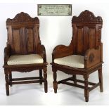 A pair of large late Victorian pitch pine carved Armchairs, in the style of Jas.