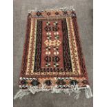 An Indian designed Wall Hanging / Rug, with large cream border, the entire on a rust ground,