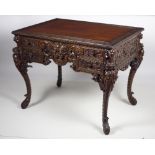 A late 19th Century carved Chinese Export wooden Desk, the plain top with blind fretwork border,