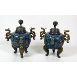 A pair of attractive 19th Century Chinese cloisonné and brass mounted tripod Urns with covers,