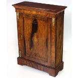 A Victorian walnut Side or Pier Cabinet, the plain top over an inlaid and shaped frieze,