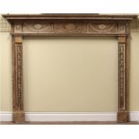 An early 19th Century George III style carved pine Fireplace,