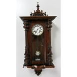 An attractive Victorian walnut Vienna Wall Clock, the finial top over a glazed opening,