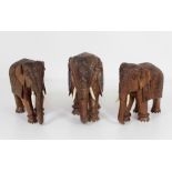 A group of three heavy carved and decorated wooden Elephants,