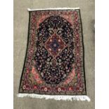 A good quality and attractive Eastern Rug, with floral large border on a rose ground,