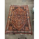 An attractive orange and blue ground Oriental Rug, with multiple borders,