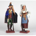 A pair of colourful 19th Century Continental hand painted dried paper Figures, of Austrian Peasants,