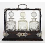 A fine quality Victorian rosewood three bottled Tantalus with plated mounts, by Mansfield,