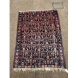 A small Oriental Rug or Wall Hanging, with single floral border and profusely decorated centre,