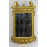 A George III style giltwood Mirror, with swan neck pediment centred by a basket of flowers,