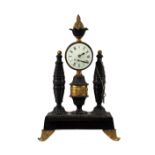 An early 19th Century Empire bronze Mantel Clock, the circular enamel dial with Roman numerals,