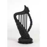 A very well carved 19th Century bog-oak Harp, decorated with shamrocks, 25cms (9 3/4") high.