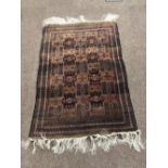 A good Oriental Rug, the dark ground with multiple cartouches, approx. 112cms x 178cms (48" x 70").