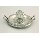 An attractive early Victorian circular two handled silver Inkwell, with a moulded glass inset,