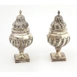 A very unusual and important pair of large early George III English silver Sugar Castors, London c.