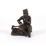 20th Century Russian School A small bronze Figure of a bearded Gentleman seated in winter attire