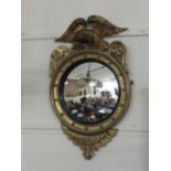 A George III giltwood Wall Mirror, the convex plate within a reeded ebony slip,