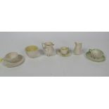 A collection of varied Belleek Items, to include cups and saucers, cream jugs, and a sugar bowl,