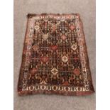 An attractive early 20th Century Oriental Rug, of rust ground, with large cream border,