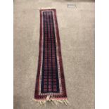 A very narrow dark blue ground Oriental Runner,