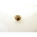 9K YELLOW GOLD PEARL AND GARNET CLUSTER RING. 5MM CENTRE GARNET IN A CLAW SETTING SURROUNDED BY 8,
