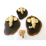 4 CARVED IVORY ELEPHANT HEADS – 2 LARGE ON PLAQUES, SMALL ON PLAQUE AND LOOSE SMALL (DAMAGED)