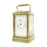 Good small English brass repeater carriage clock striking on a bell, the dial indistinctly inscribed