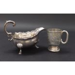 Georgian style silver cream jug with piecrust rim and scallop shell feet, hallmarks rubbed, 6" long;