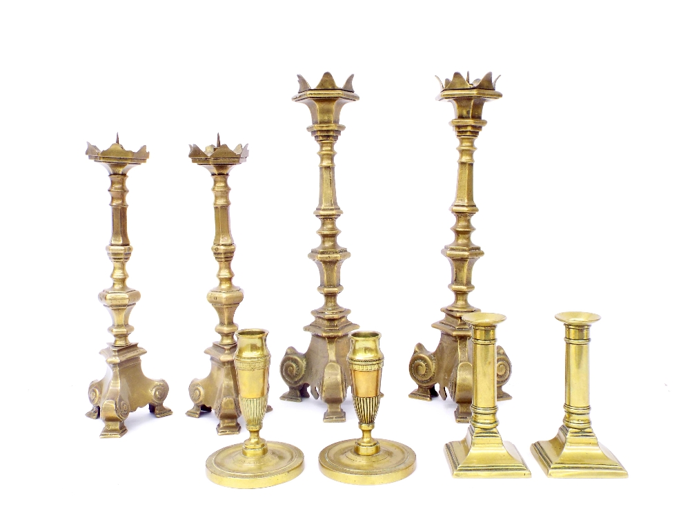 Four pairs of antique brass candlesticks, the largest 14.5" (8)