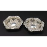 Pair of Edwardian silver bonbon dishes, each embossed with flowers and diaper panel borders, maker