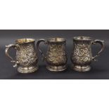 Three Georgian embossed silver baluster tankards to include makers Benjamin Bickerton London 1765;