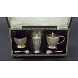 Early 20th century silver cased cruet set, comprising salt, mustard and pepper, with blue glass