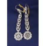 Attractive pair of period platinum and diamond drop earrings, with graduated links over circular