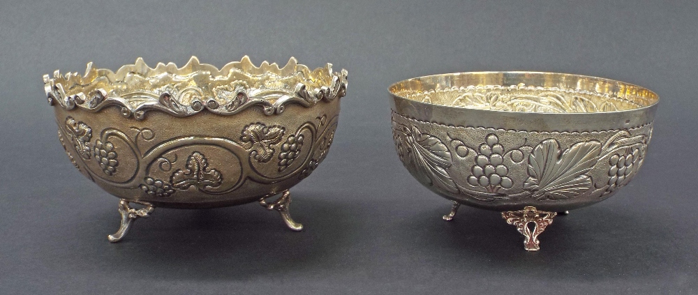 Two Continental '830' silver pedestal bowls, the smaller embossed with grapevine upon three