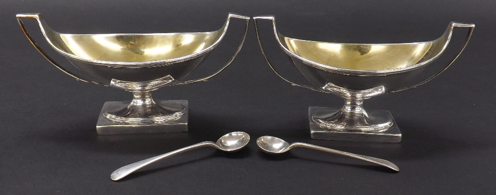 Pair of George III silver open oval twin handled pedestal salts, with gilt interiors and engraved