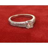 (201600145-1-A) Platinum princess-cut solitaire diamond ring with diamond set shoulders, 0.30ct