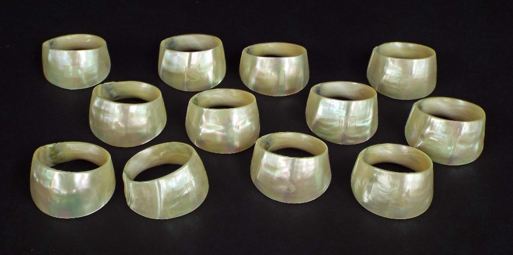 Set of twelve mother of pearl napkin rings, six inscribed with the letter 'S', the other six