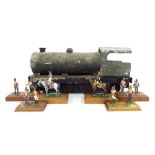 Primitive tin model of a steam locomotive, 9" high, 18" long; together with six painted lead figures