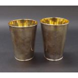 Graduated pair of George III silver beakers with gilded interiors, Sheffield 1816 and 1817, 5" and
