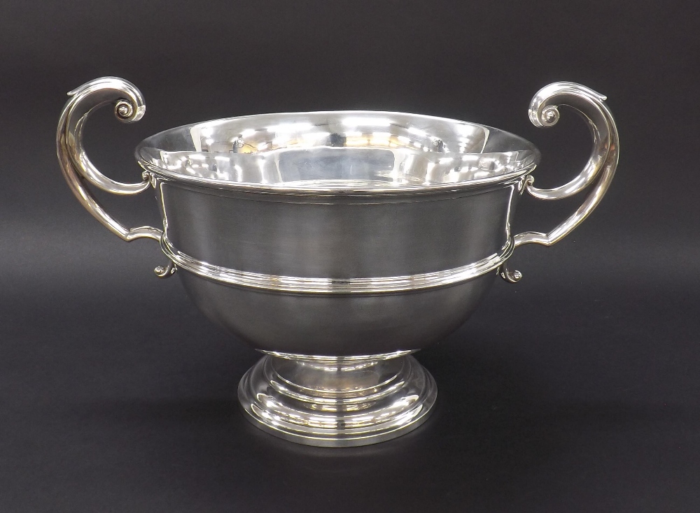 Edwardian silver twin-handled pedestal bowl, with c scroll handles with shield affixing upon a