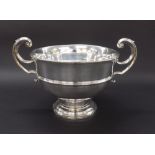 Edwardian silver twin-handled pedestal bowl, with c scroll handles with shield affixing upon a