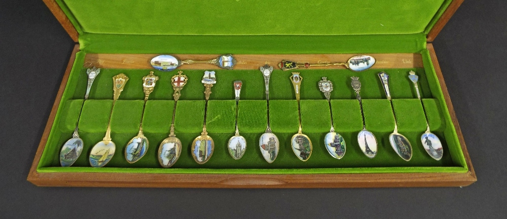 Collection of silver and white metal souvenir spoons, with enamelled decoration, within an